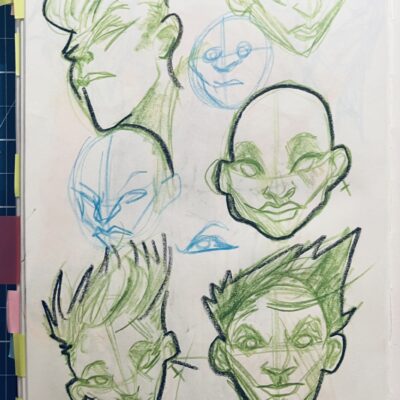 Photo of a page from a sketchbook, with a set of studies of women's faces, using green pencil.