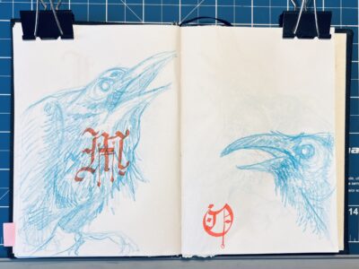 Pages from a sketchbook, with drawings of crows in blue pencil, with gothic-style letters drawn over them.